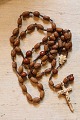 Nice old rosary with wooden beads. Length: 68cm.