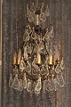 Big old crystal chandelier from the early 1900s with lots of large leaf shaped 
glass prisms.
H:100cm. Dia.:60cm.