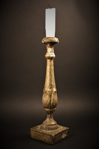 Antique Swedish 1800 century candlestick in wood with remnants of old gold 
coating and with a really fine patina.