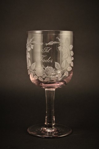 Old commemorative glass from Holmegaard glassworks with fine engraved floral 
decorations and writing "Til Fader" H:16,5cm. Dia:7.5cm.