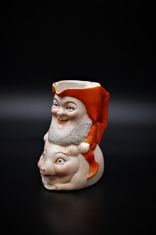 Old Christmas pitcher in porcelain 
of Santa riding on pig. Height: 11,5cm.