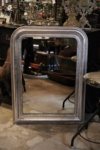 French 1800 century Louis Philippe silver fireplace mirror with fine decorated frame with pearl edge and original old mirror glass.H:104cm. W:77cm.