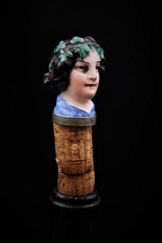 Funny, old wine stopper in painted porcelain with bust of Nobel Woman.
