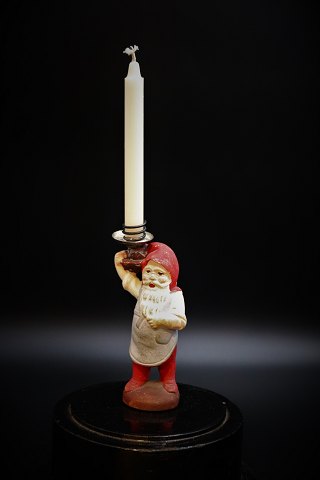 little old painted Santa Claus carrying a small Christmas candle.
Height: 12cm.