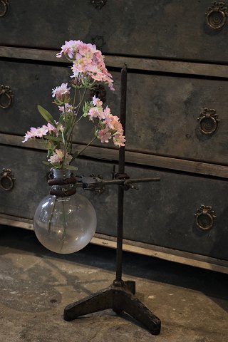 Raw old French "Laboratory vase" consisting of raw iron stand with glass flask 
for a single flower...