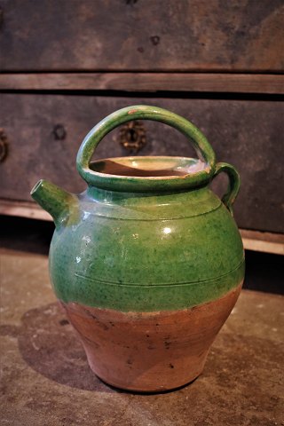 Old pottery jars with pouring spouts from the South of France in green glaze…