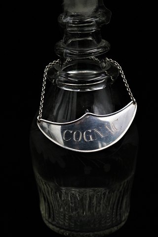 Gammelt spiritus skilt " Cognac " i sølv...