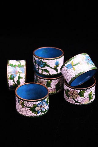 Fine, old napkin rings in brass and cloisonne with floral motifs...