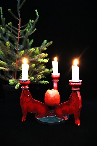 Old Swedish Christmas candlestick in carved wood with 3 pigs holding a candle 
and with an apple in the middle...