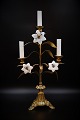 Old French church candlestick in bronze with space for 3 candles and decorated with 3 fine, old white opal glass flowers.H:44cm. W:26cm.
