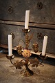 Old French church candlestick in gilded bronze decorated with 1 fine old colored porcelain flower. H:33cm. W:28cm.