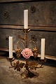 Old French church candlestick in gilded bronze decorated with 1 fine old colored porcelain flower. H: 33cm. W: 28cm.