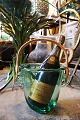 Old wine / champagne cooler in transparent green glass with braided bamboo 
handle from the 70s...