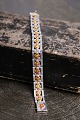 Old silver bracelet with inlaid enamel flowers in orange colour. 
Length 18cm...