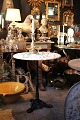 Old French cafe table with cast iron base and grey/white round marble top...