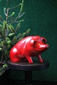 Decorative, old piggy bank in red painted terracotta from the 40s with a fine 
patina...